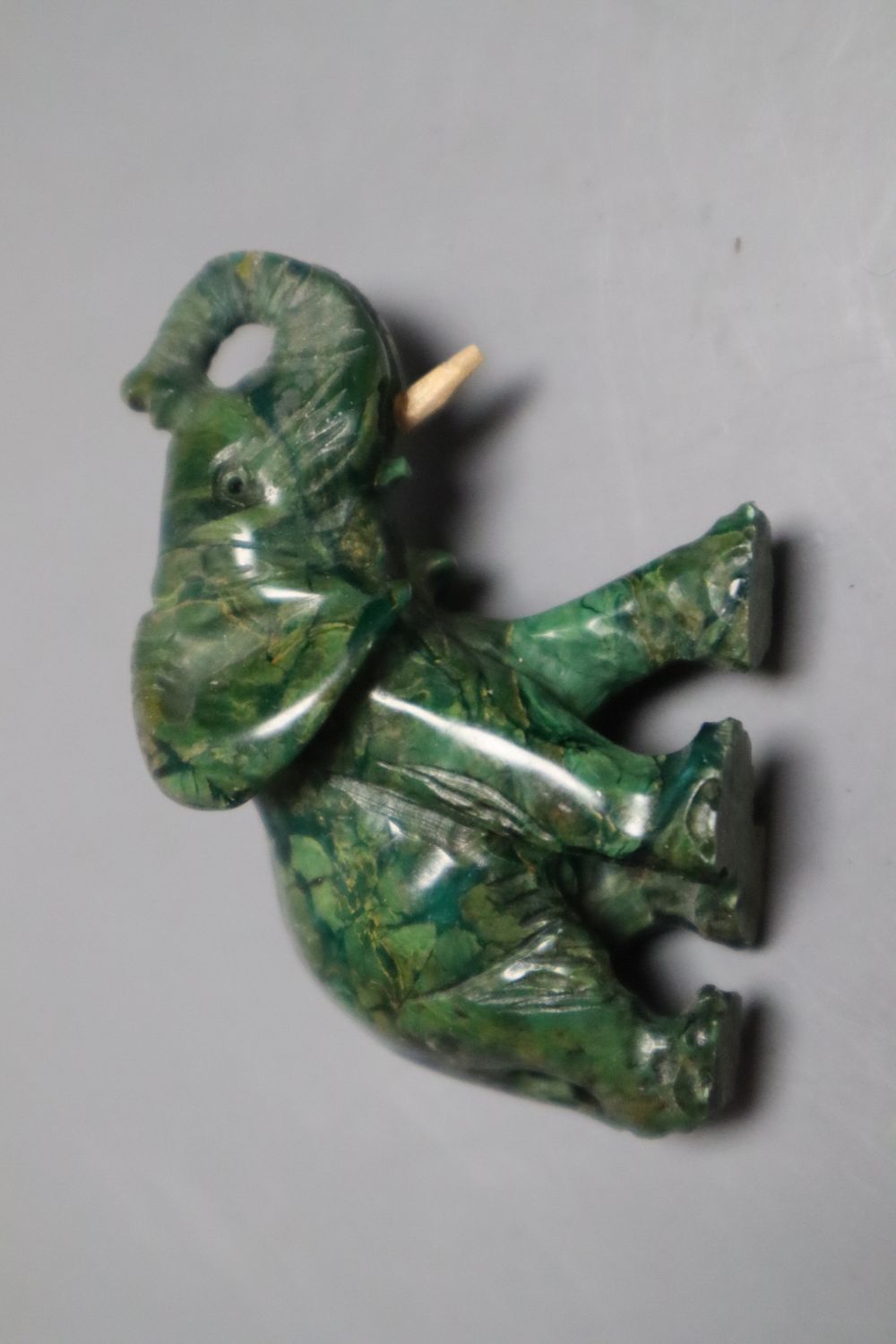 A Chinese pale celadon and russet jade figure of a boy, 4.8cm, a similar carved pendant together with a yellow metal and hardstone set